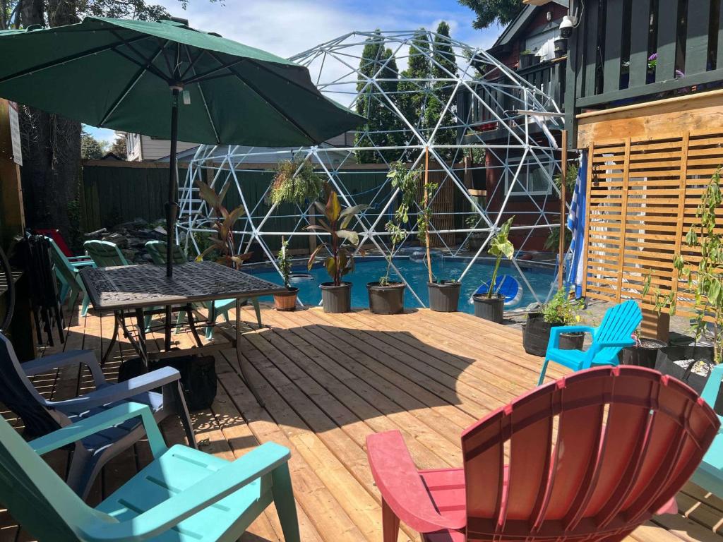 a patio with chairs and a table and an umbrella at Poolside Hideaway Heated Pool All Year Ideal for Groups Sleeps 6 plus in Victoria