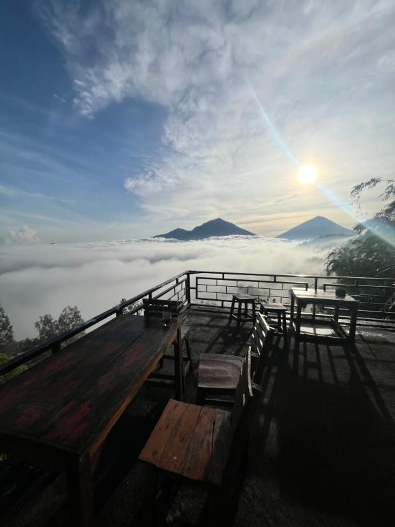 a group of benches sitting on top of a mountain at Tukadsari camping in Kintamani