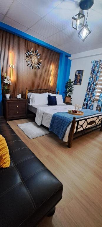 a bedroom with a large bed with a blue wall at Cozy Comfy Budget Friendly in San Fernando