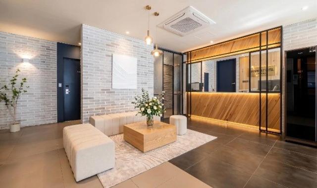a living room with a couch and a coffee table at Gwangalli Brown Dot Gwangalli Beach, Busan in Busan