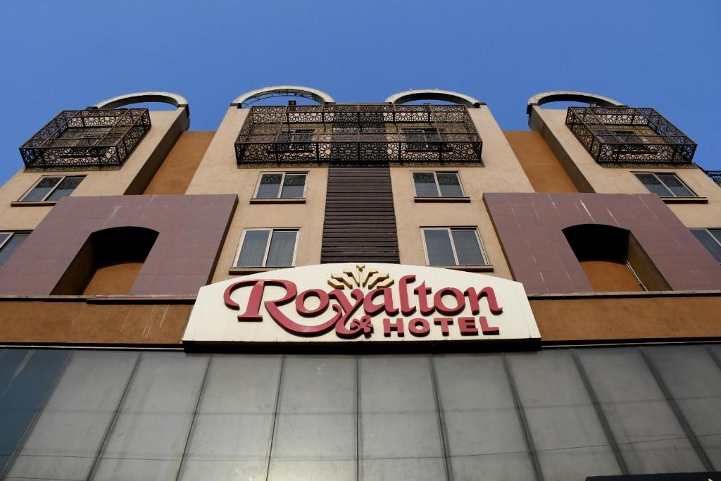 a building with a hotel sign in front of it at Royalton Hotel Rawalpindi in Rawalpindi