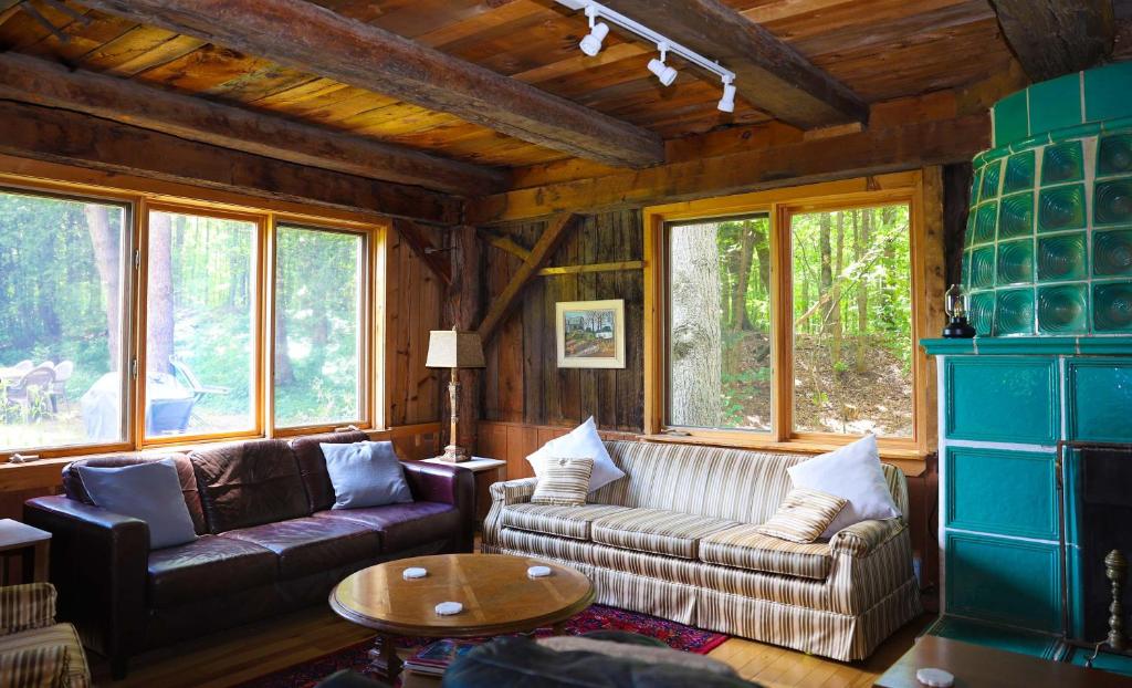 a living room with a couch and a table at The Barn - A Unique Gathering Place in Sainte-Cécile-de-Masham