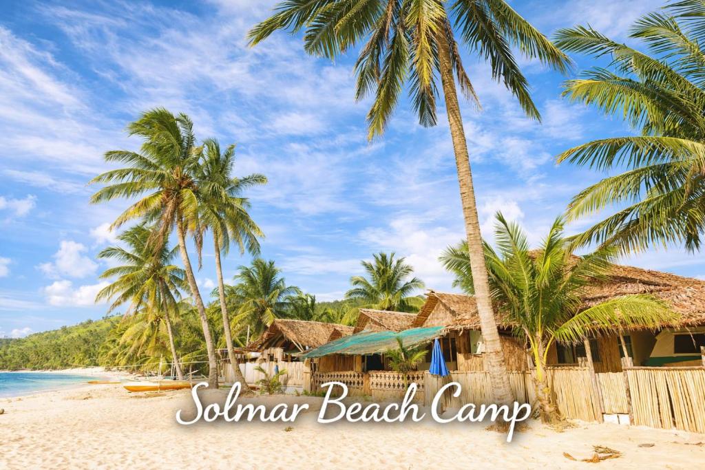 a beach with palm trees and a resort at Solmar Beach Camp in San Vicente