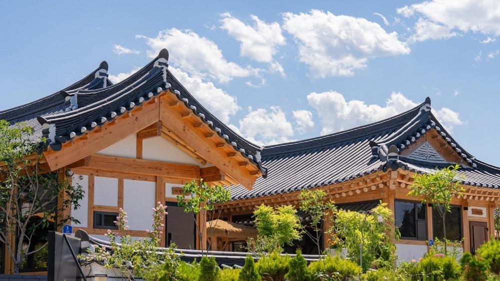 a building with a chinese roof on top of it at Hanok Stay ieum in Gangneung
