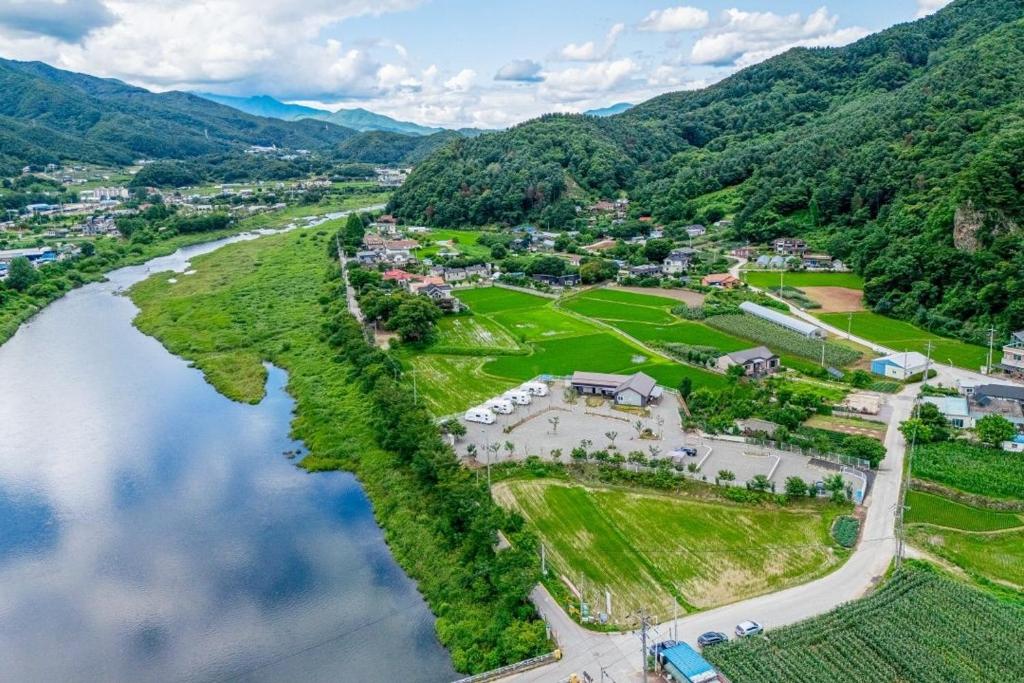 an aerial view of a town next to a river at Gapyeong JY Camping Caravan in Gapyeong
