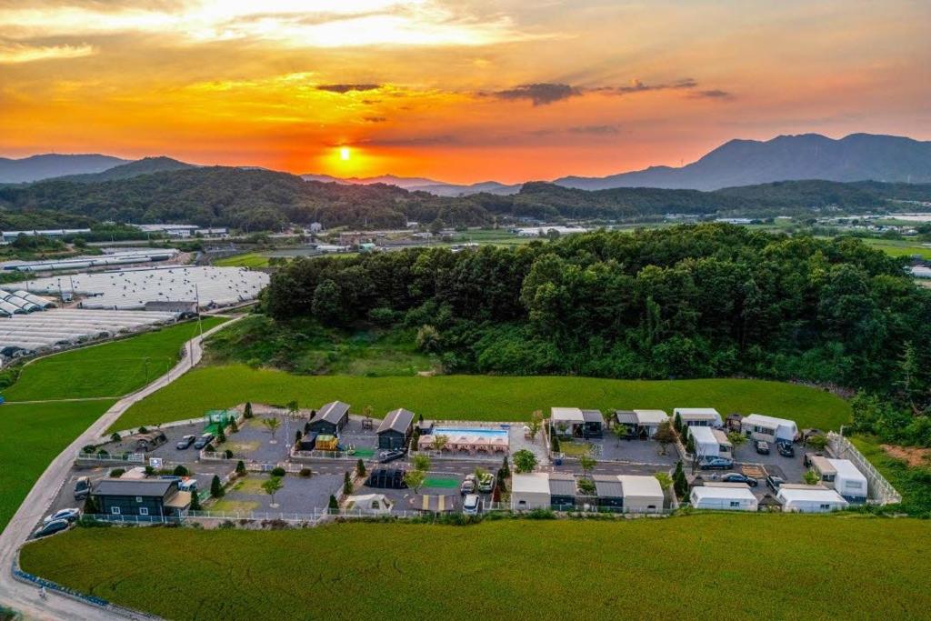 an aerial view of a large apartment complex with a sunset at Pocheon Choice Camp Caravan in Pocheon