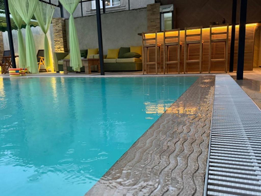 a swimming pool with blue water in a building at Kaya Telavi in Telavi