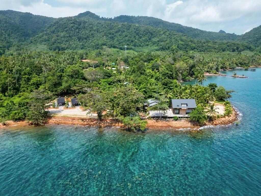 an island in the water with a house on it at Wave & Vibes Koh chang in Ban Chek Bae (1)