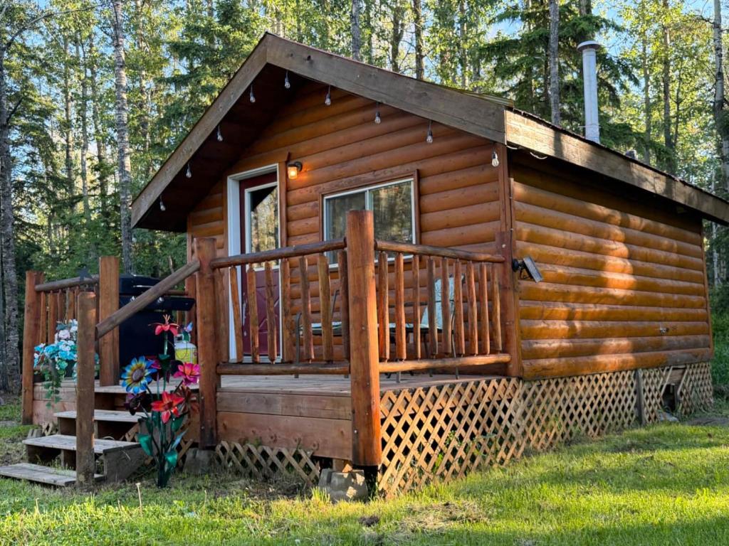 a log cabin with a porch and a deck at The Sheep Camp cabin- Bear Creek Cabins in Winfield