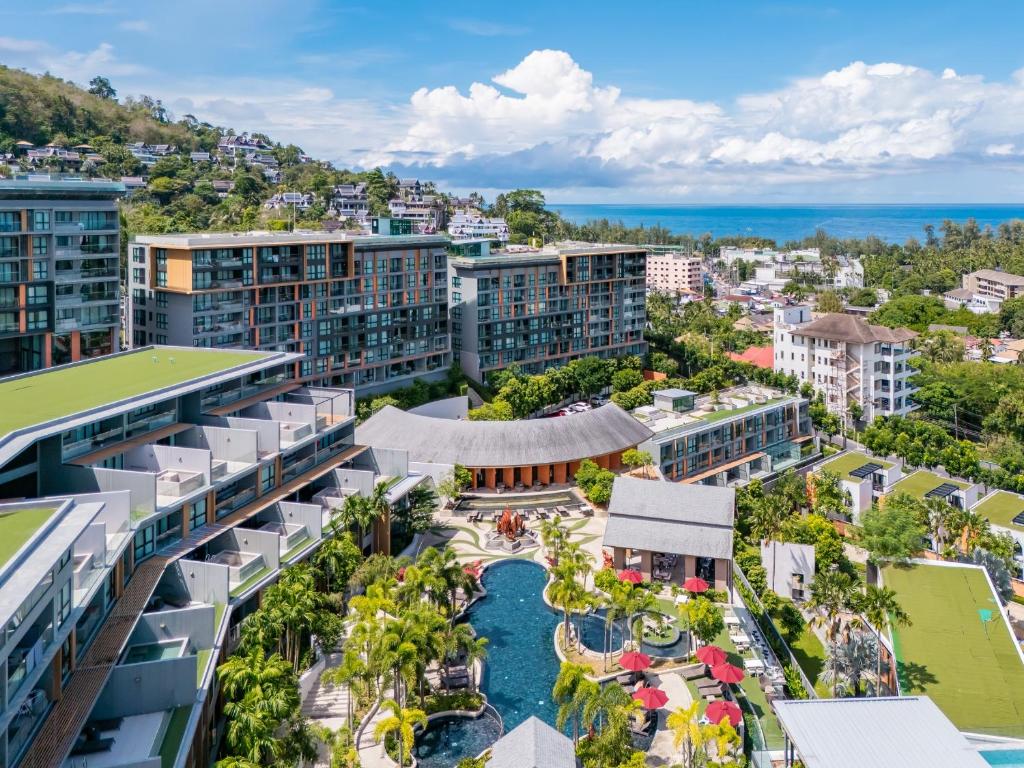 an aerial view of a city with buildings at Mida Grande Resort Phuket Official Account in Surin Beach