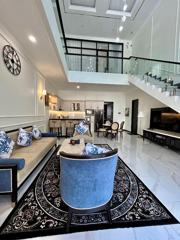 a large living room with a couch and a table at Royal Classic Puncak in Cisarua