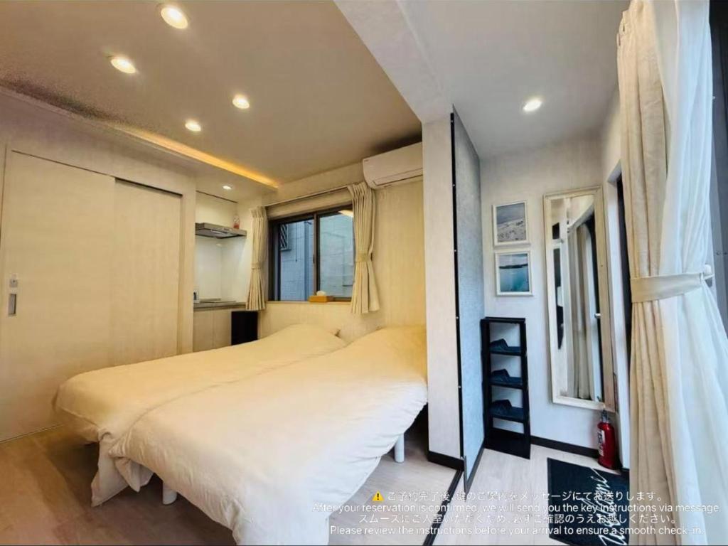 a bedroom with two beds and a window at SnowMapleHouse西川口 in Kawaguchi