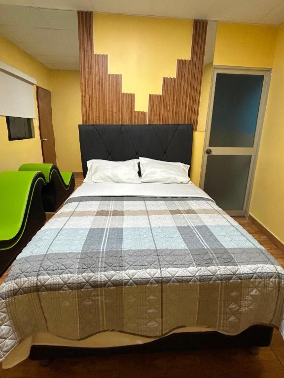 a bedroom with a large bed in a room at Hostal La Huerta in Huánuco