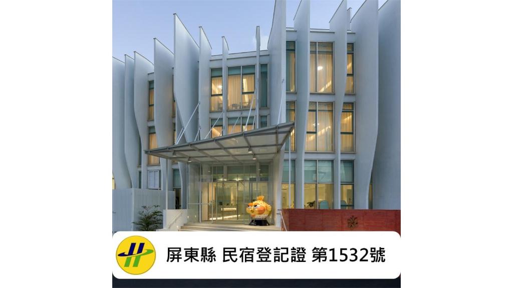 a man standing in front of a building at Orient Luxury Hotel Kenting in Hengchun South Gate