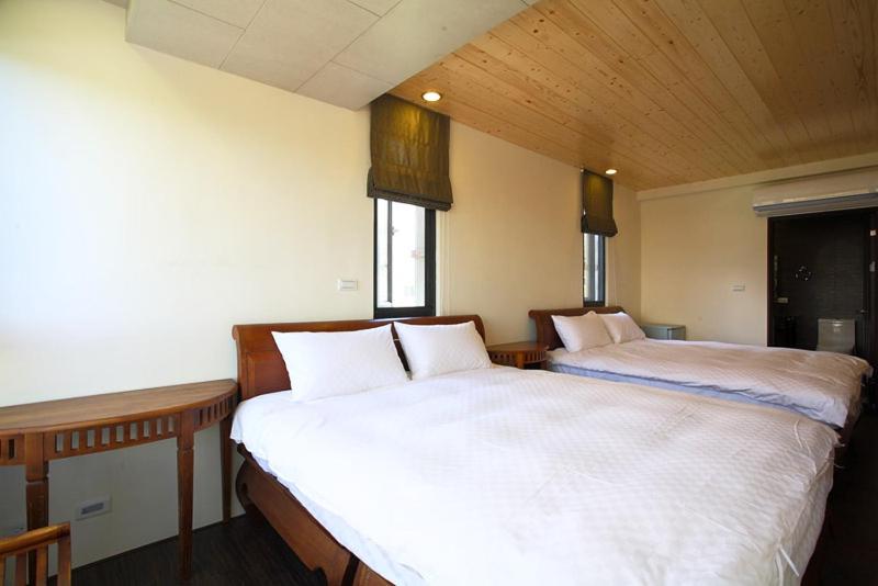 Postel nebo postele na pokoji v ubytování Sung-Ding Guesthouse