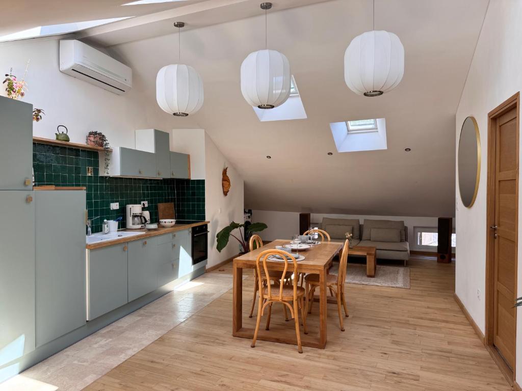 a kitchen and dining room with a table and chairs at Confort et élégance au cœur de Florac in Florac
