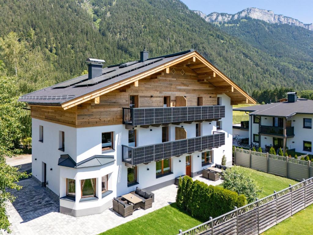 an aerial view of a house with solar panels on the roof at Alpenrose Appartements Waidring in Waidring