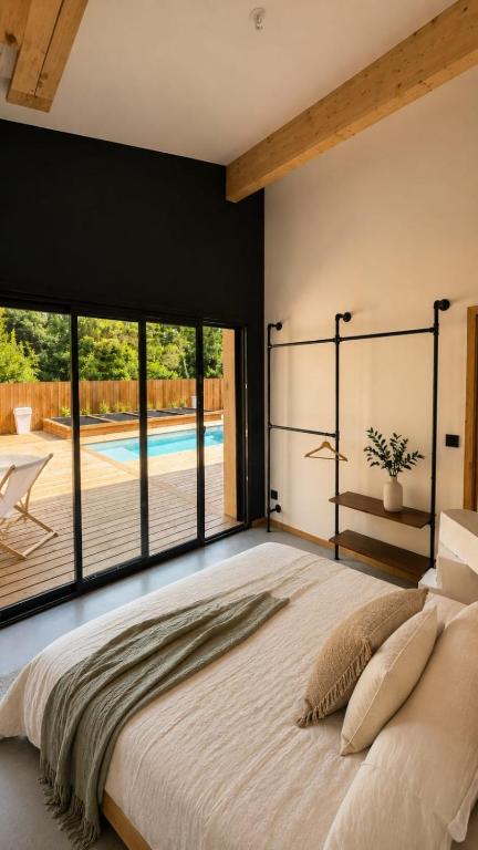 a bedroom with a large bed with a large window at La Villa Véga 8 pers in Martillac