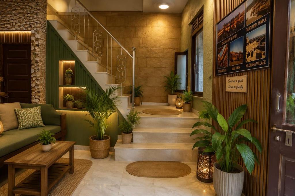 a lobby with a staircase with potted plants at Rumis Jaisalmer in Jaisalmer
