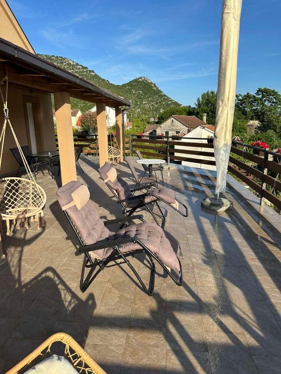 a group of chairs sitting on a patio at Casa di Kiara, Skadar Lake in Dodoši