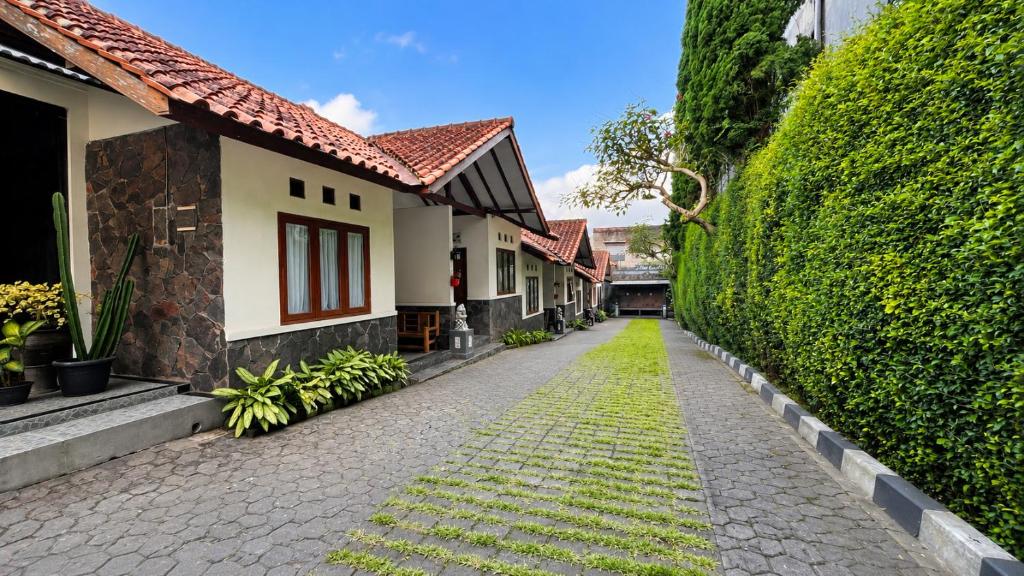 a cobblestone alley in front of a house at Cemara Asri Guesthouse in Lembang