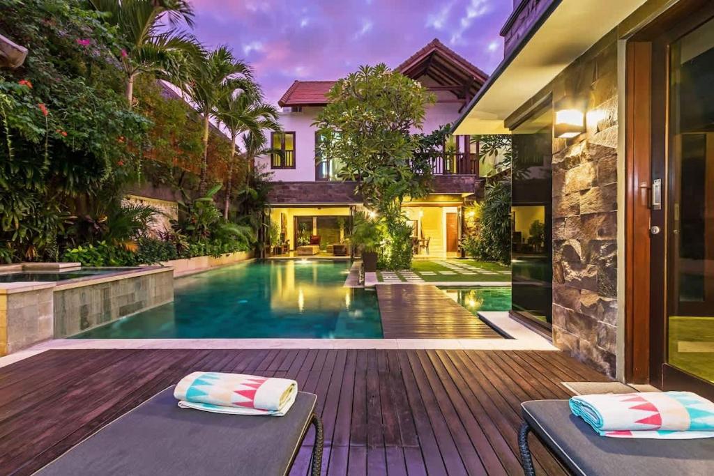 a swimming pool in the backyard of a house at Villa Yasmin in Seminyak