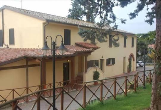 a large house with a fence in front of it at Hotel Collina di San Sisto in San Sisto