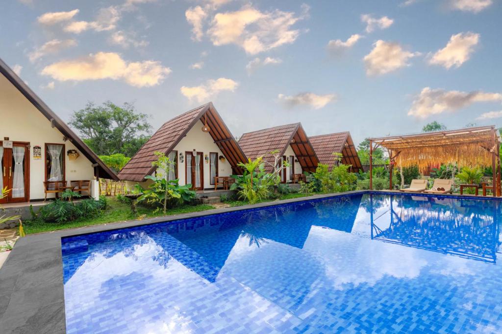 an image of a villa with a swimming pool at Maskot Penida Cottage in Nusa Penida