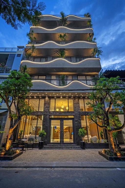 a tall building with glass doors in front of it at MAIA Boutique Hotel Da Nang in Danang