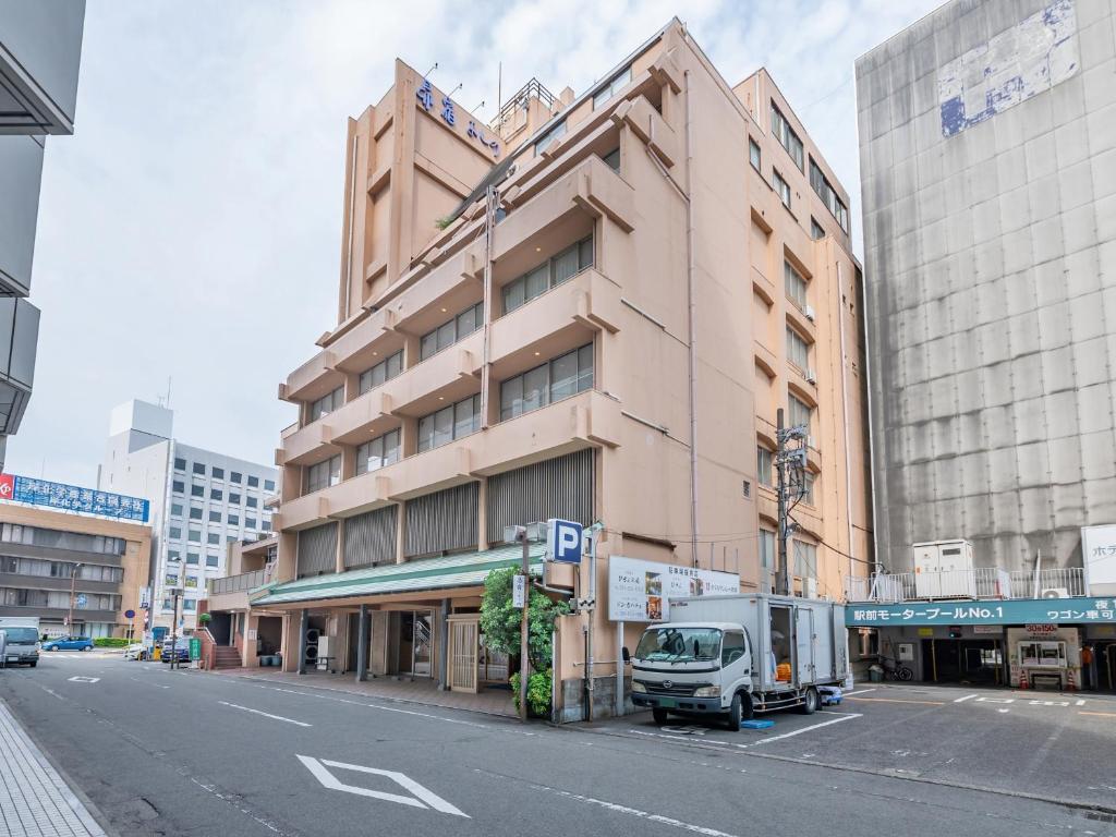 a white truck parked in front of a building at Subaruyado Yoshino in Tokushima