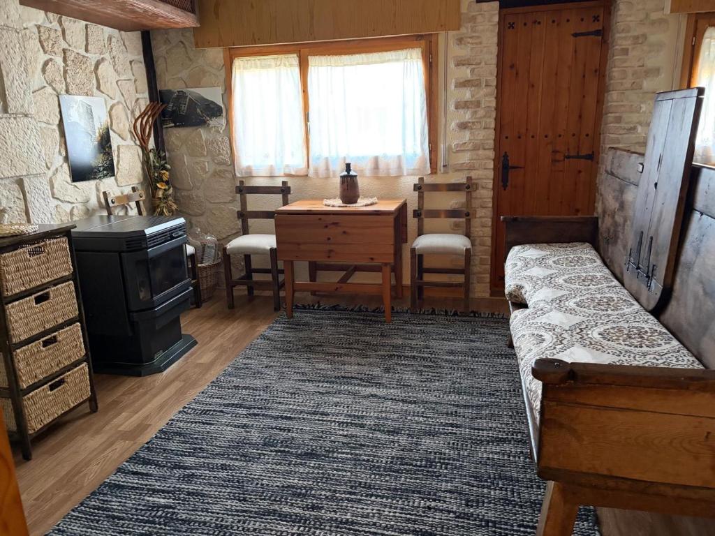 a living room with a couch and a table and a stove at Apartamento Selva Blanca 9 in Villanúa