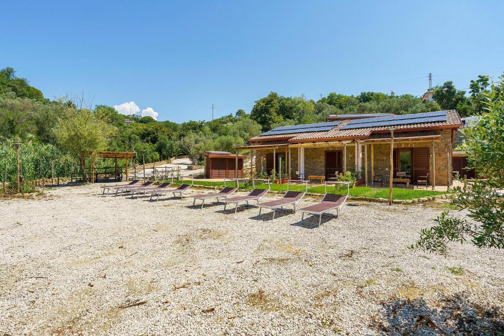 a group of chairs sitting in front of a building at Mammina Holiday Home in Casal Velino