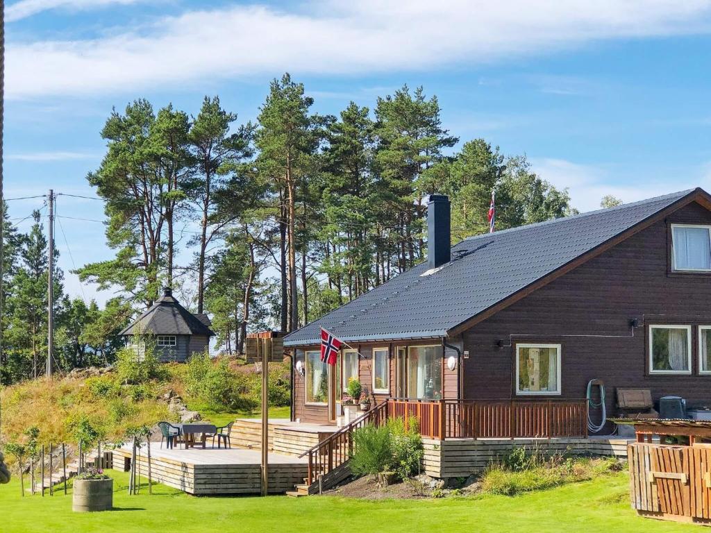 a log cabin with a deck and a house at 8 person holiday home in Jelsa-By Traum in Jelsa
