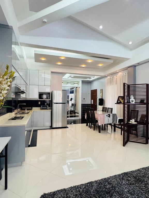 a large kitchen and dining room with a refrigerator at Anavada Suites - Davao City in Davao City