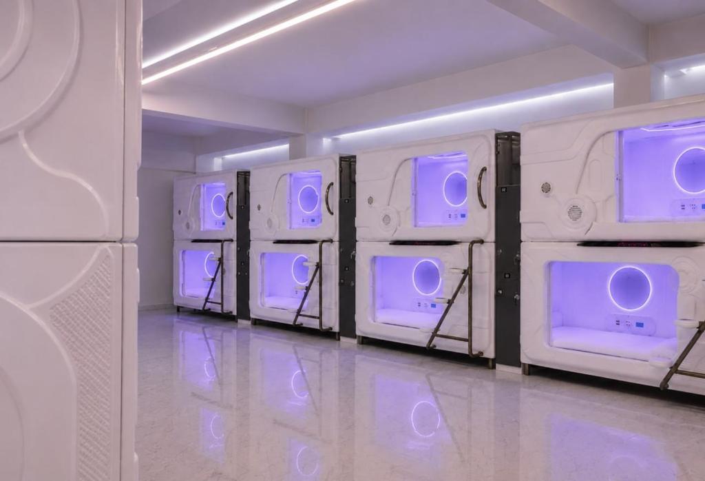 a room with a row of microwaves with purple lights at Hotel Seoul in Clark