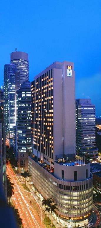 a large building in a city at night at M Hotel Singapore City Centre in Singapore