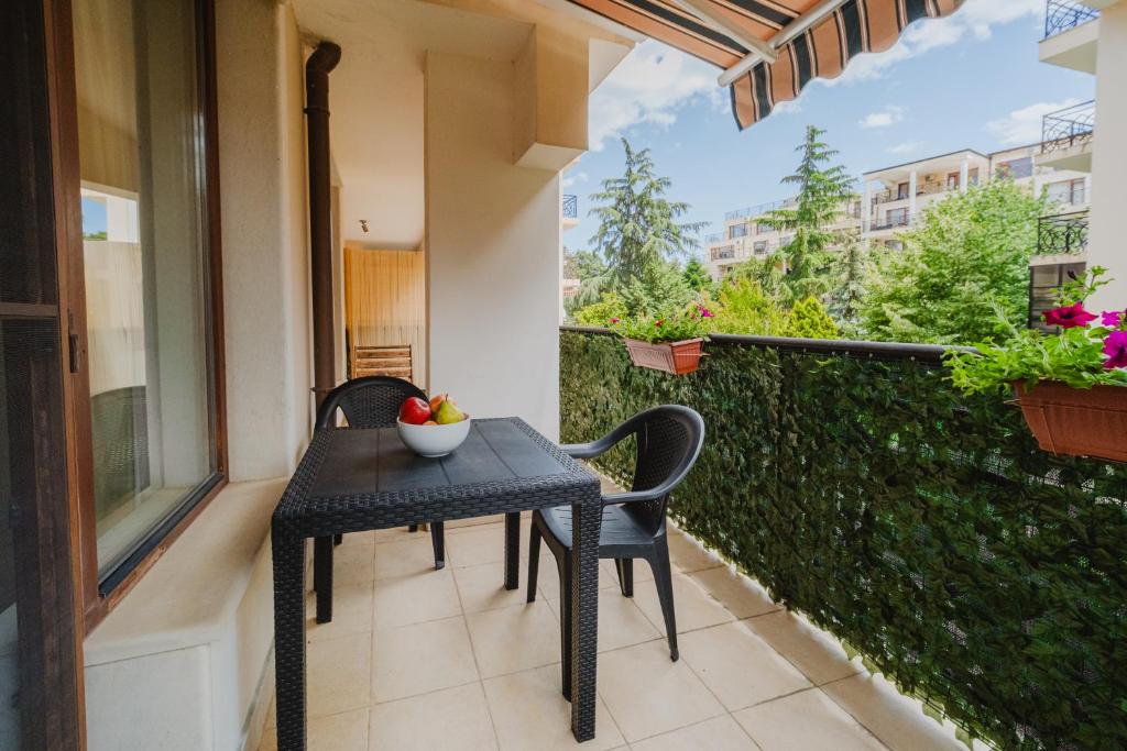 a table and chairs on the balcony of a building at Iglika Beach in Golden Sands