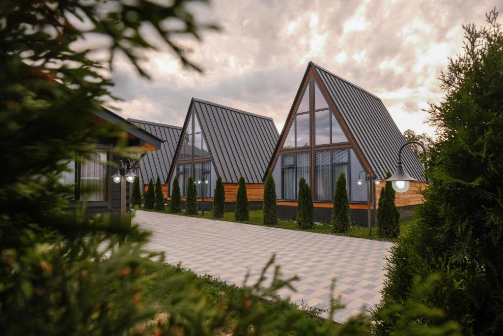 a row of houses with windows on a courtyard at Tengri Village Karakol in Karakol