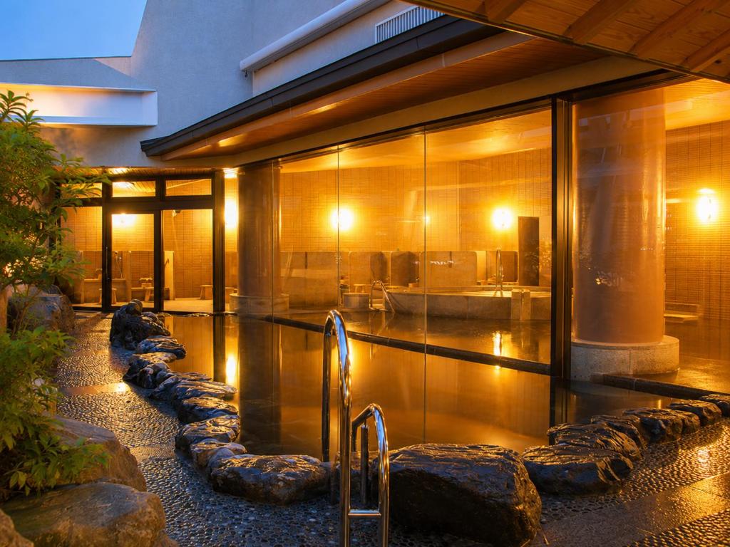 a house with a swimming pool in front of a building at City Plaza Osaka in Osaka