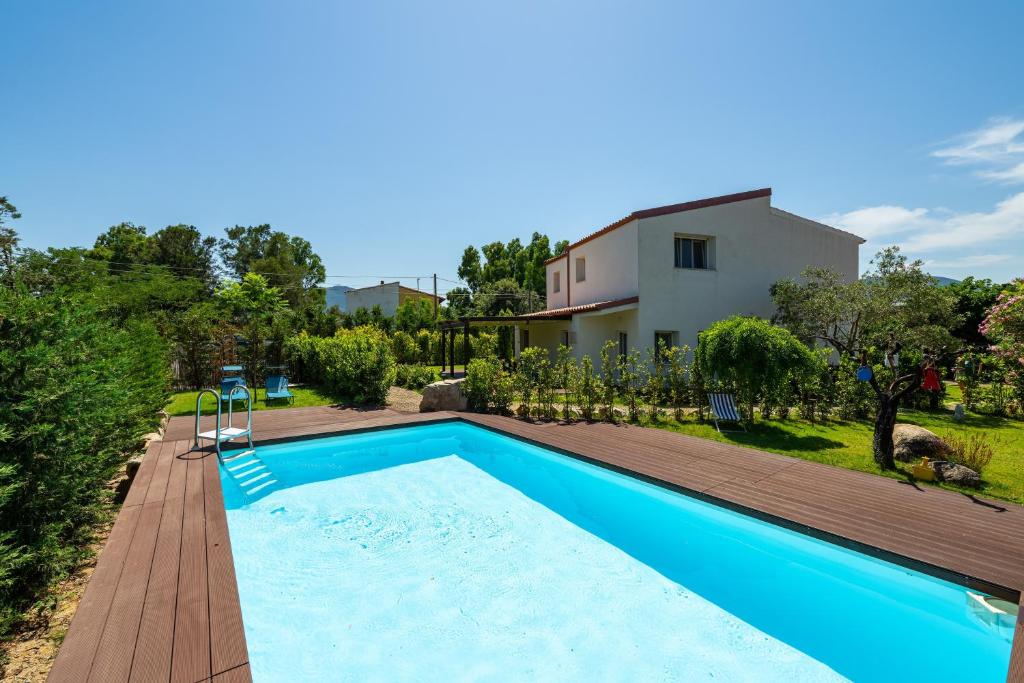an image of a swimming pool in front of a house at Macondo Agriliving Apartments in Castiadas