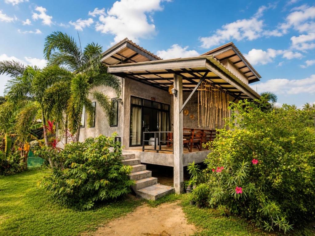 a house with a porch and stairs to it at Casa Eden - Double King Bed - Peaceful Garden Retreat - 4K SmartTV in Thong Sala