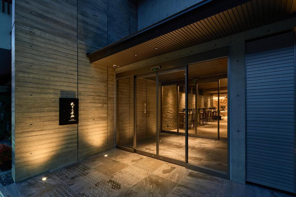 an external view of a building with glass doors at Gion Kuromatsu in Kyoto