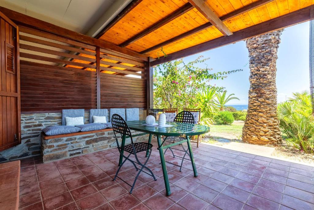 a patio with a table and chairs on a patio at Casa 2 Punta Negra Vista Mare in Stintino