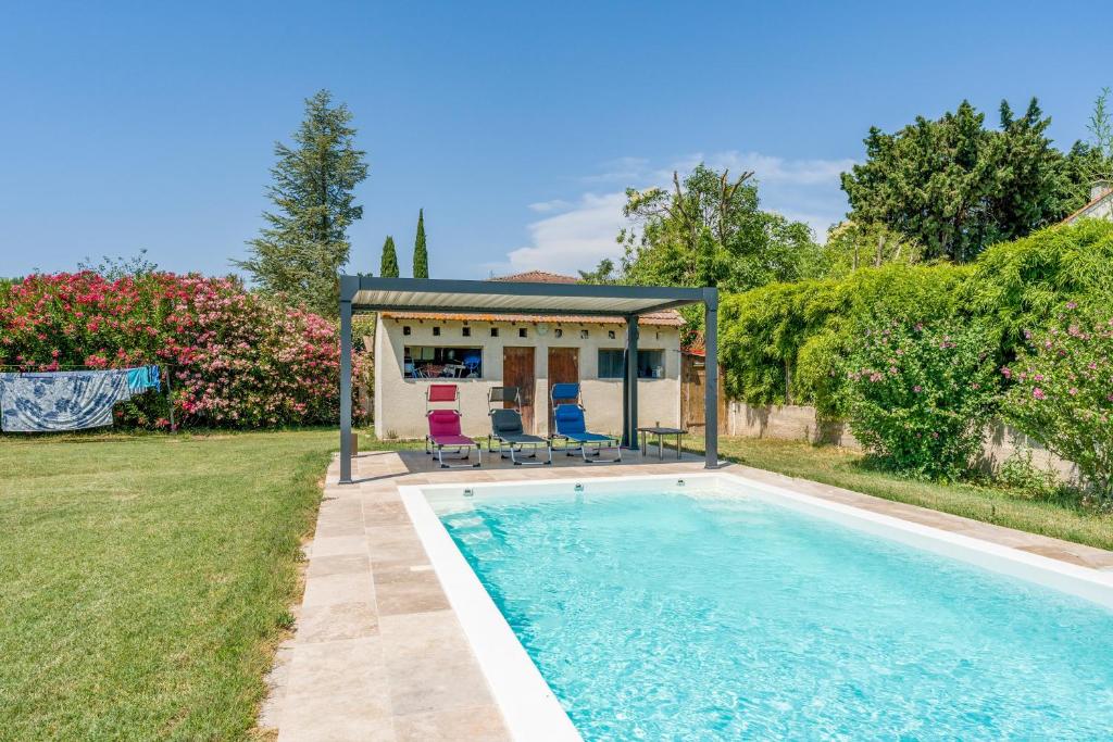 a swimming pool in front of a house at Studio piscine Alpilles in Noves