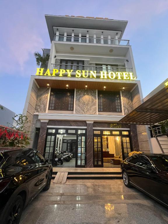 two cars parked in front of a hotel at Happy Sun Hotel in Mỹ Tho