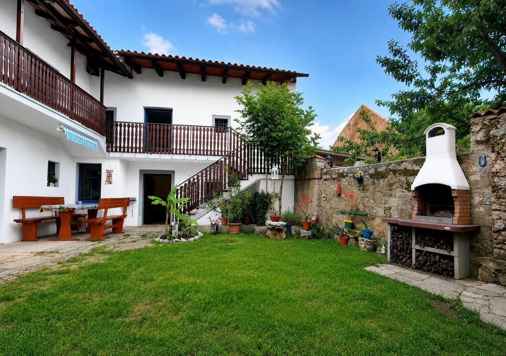 a courtyard of a house with a large bell tower at Apartma Aria&Karra in Komen