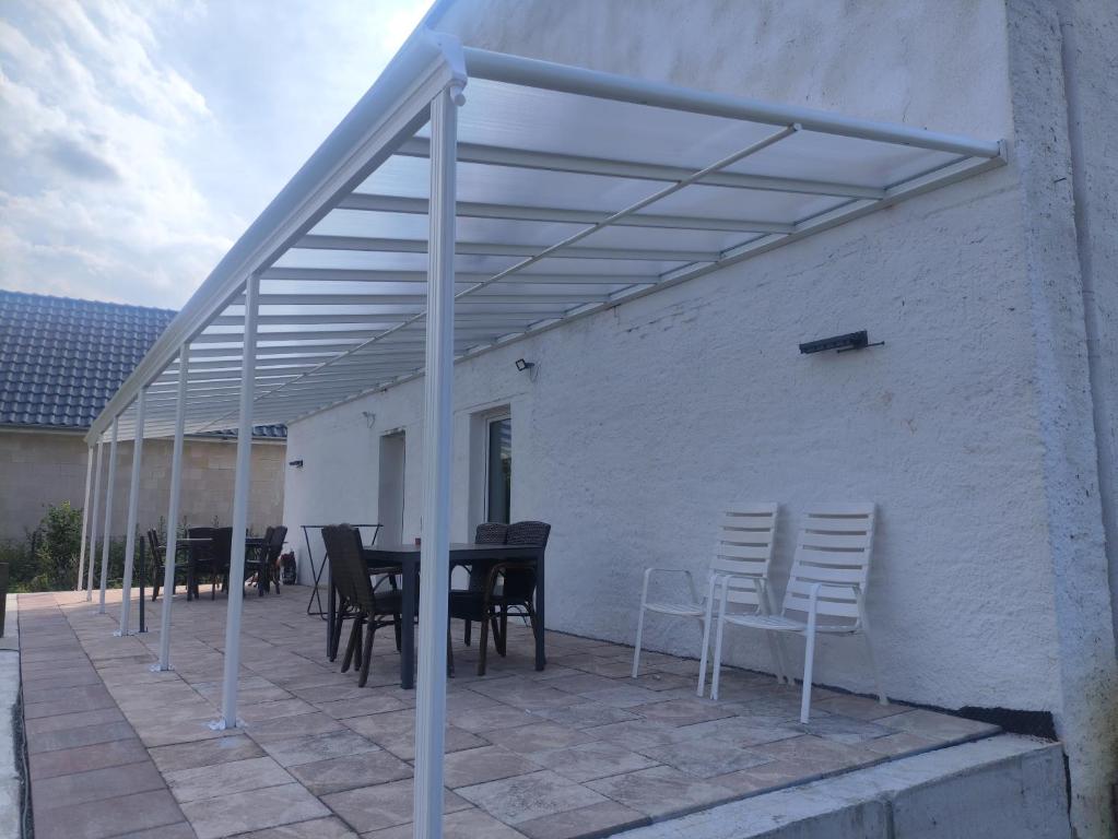 a patio with a table and chairs under awning at Ferienwohnungen Am Storchennest in Krembz bei Gadebusch in Krembz