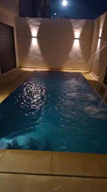 a large pool of water with two lights in it at Villa Sereine in Sidi Yahia