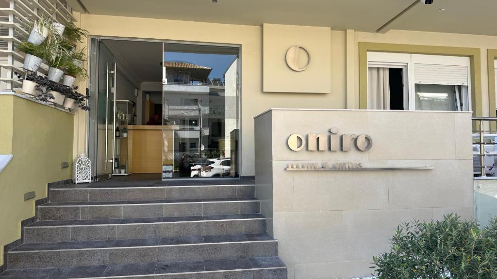 a building with a sign on the front of a building at Oniro Rooms & Suites in Leptokarya