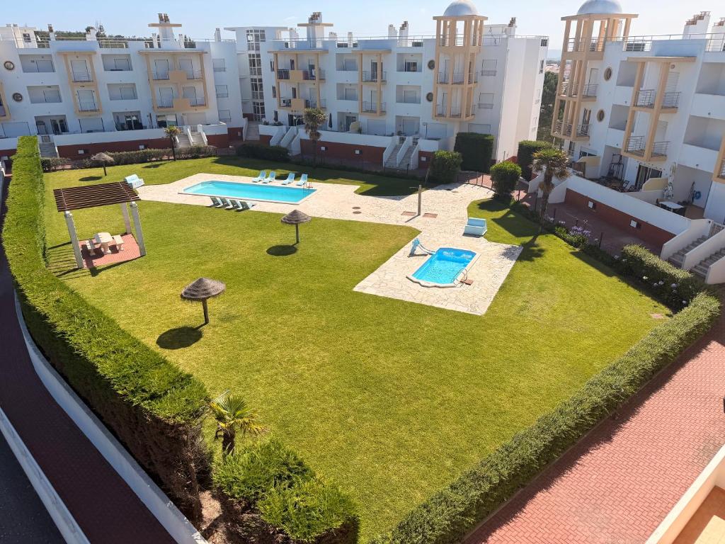 an aerial view of a lawn with a pool and some buildings at Moinho do vento in Nazaré